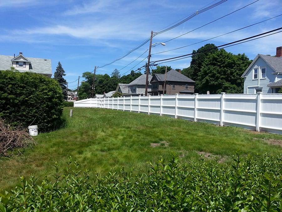 The curving white picket fence A white picket fence curving through a landscape