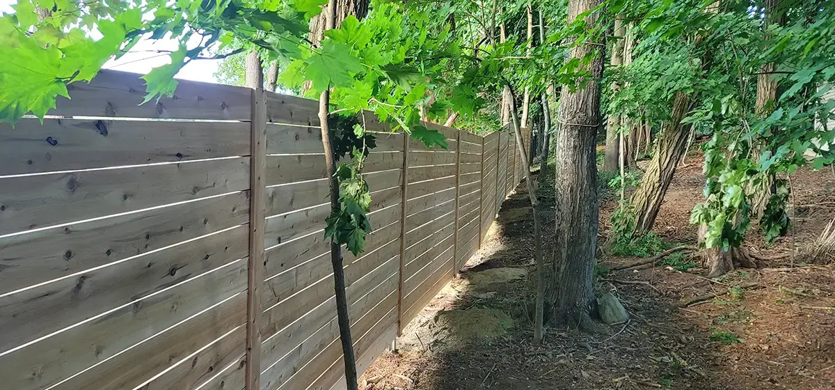Wooden fence attched with a wire fence Outdoor scene with a wooden Fence