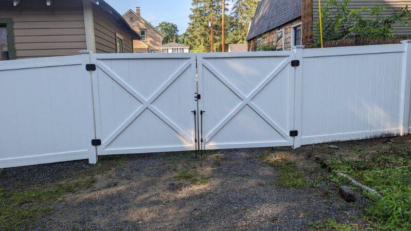 Vinyl gate A white Vinyl gate and fence set against the trees